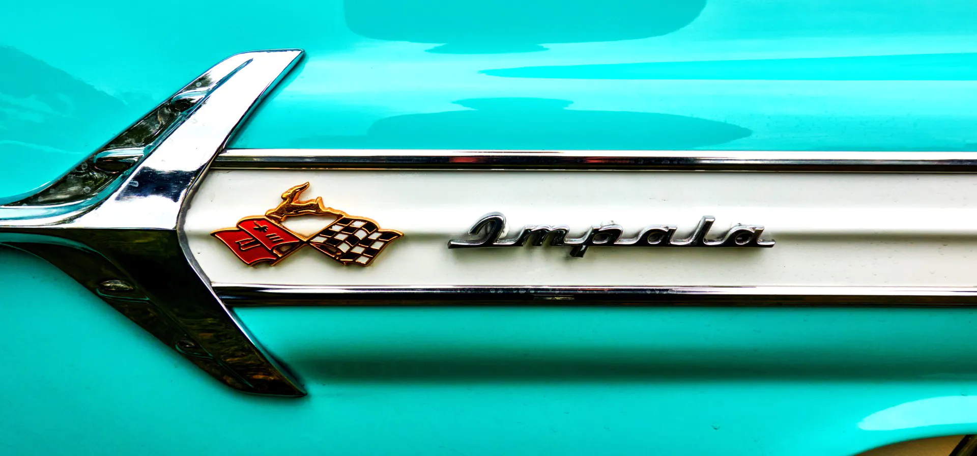 Impala lettering and logo with an antelope, two flags and an arrow on the side a Chevrolet in Lehnin, Germany, September 12, 2021.
