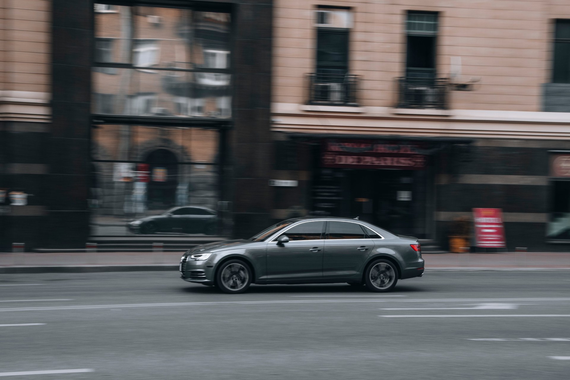Silver Audi A4 car moving on the street