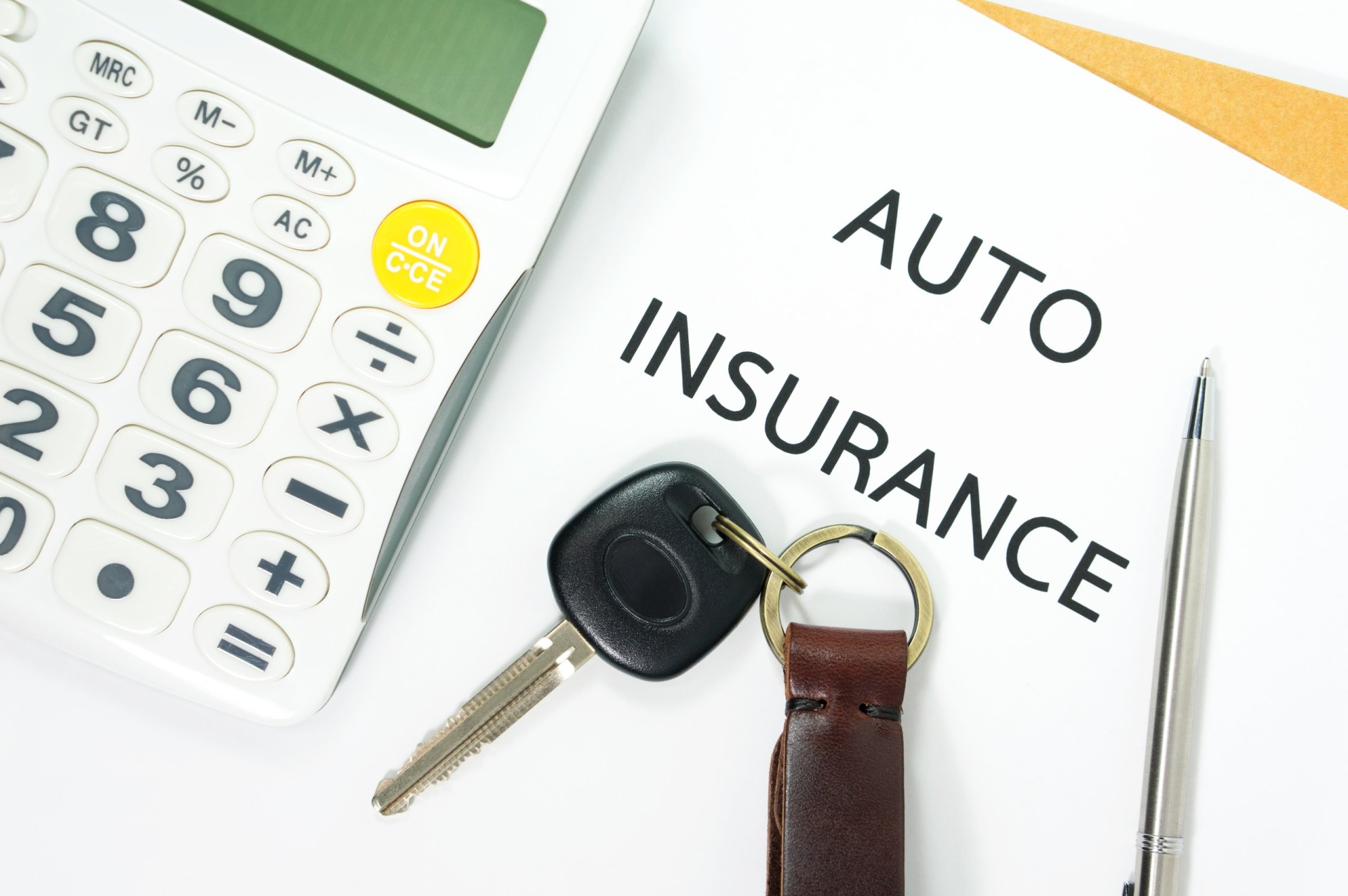 Auto insurance with car key and calculator