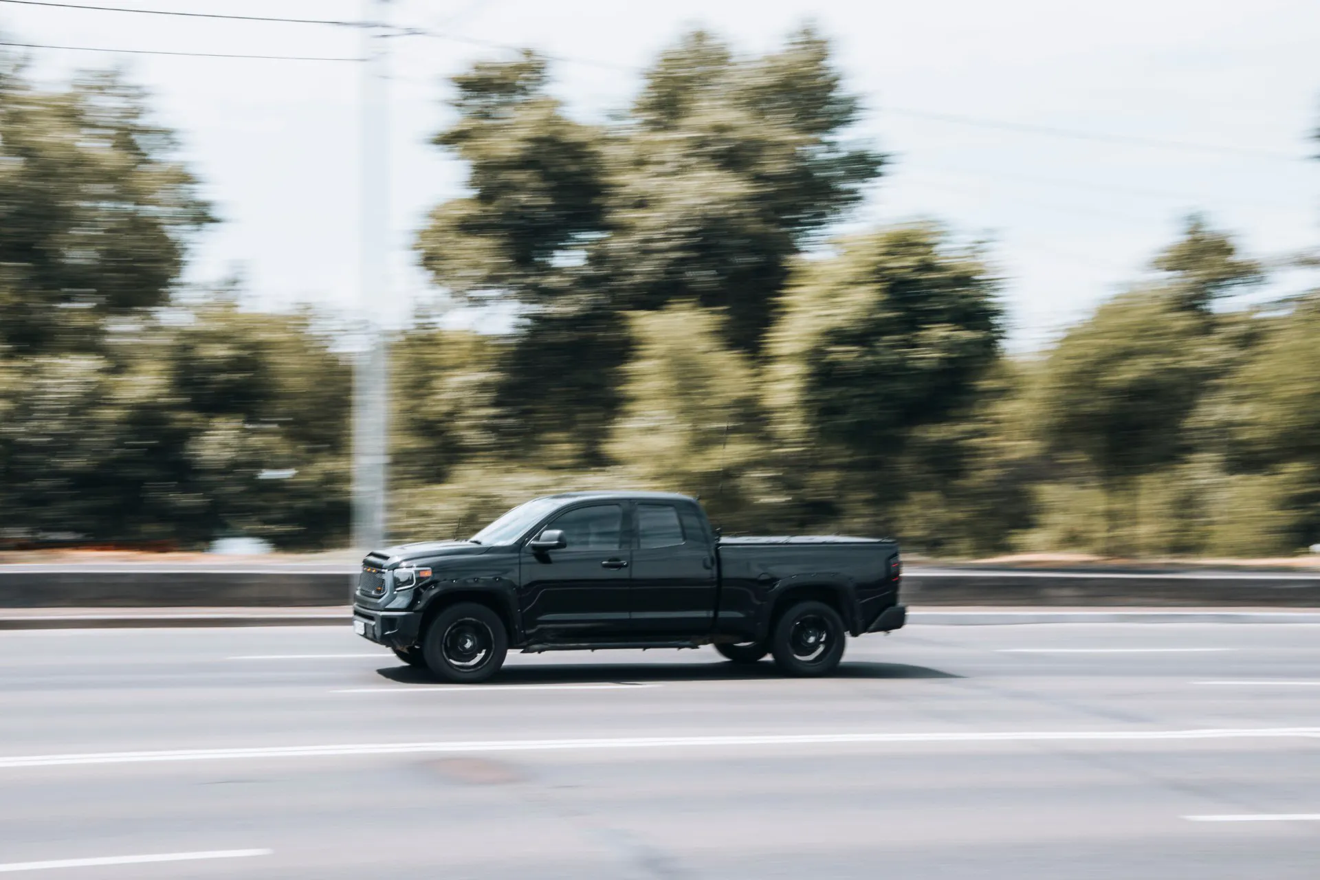 Black Toyota Tundra car moving on the street.