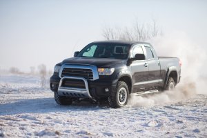 Black Toyota Tundra traveling in the snow