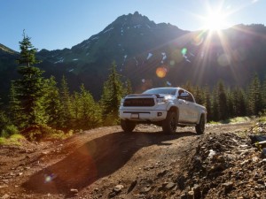 Toyota Tacoma riding on the 4x4 Offroad Trails in the mountains during a sunny summer morning.