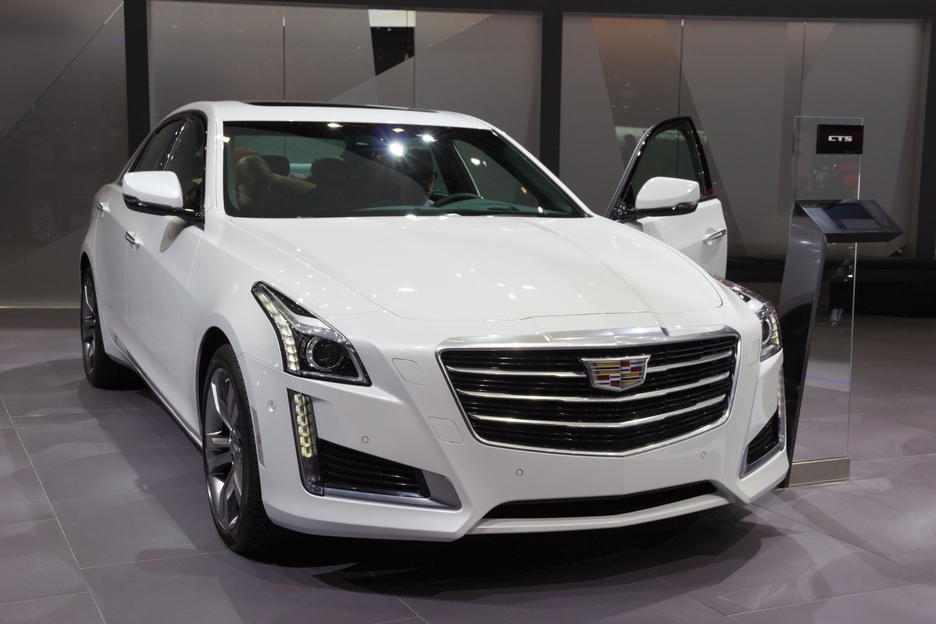 2015 White Cadillac CTS car display at an auto show