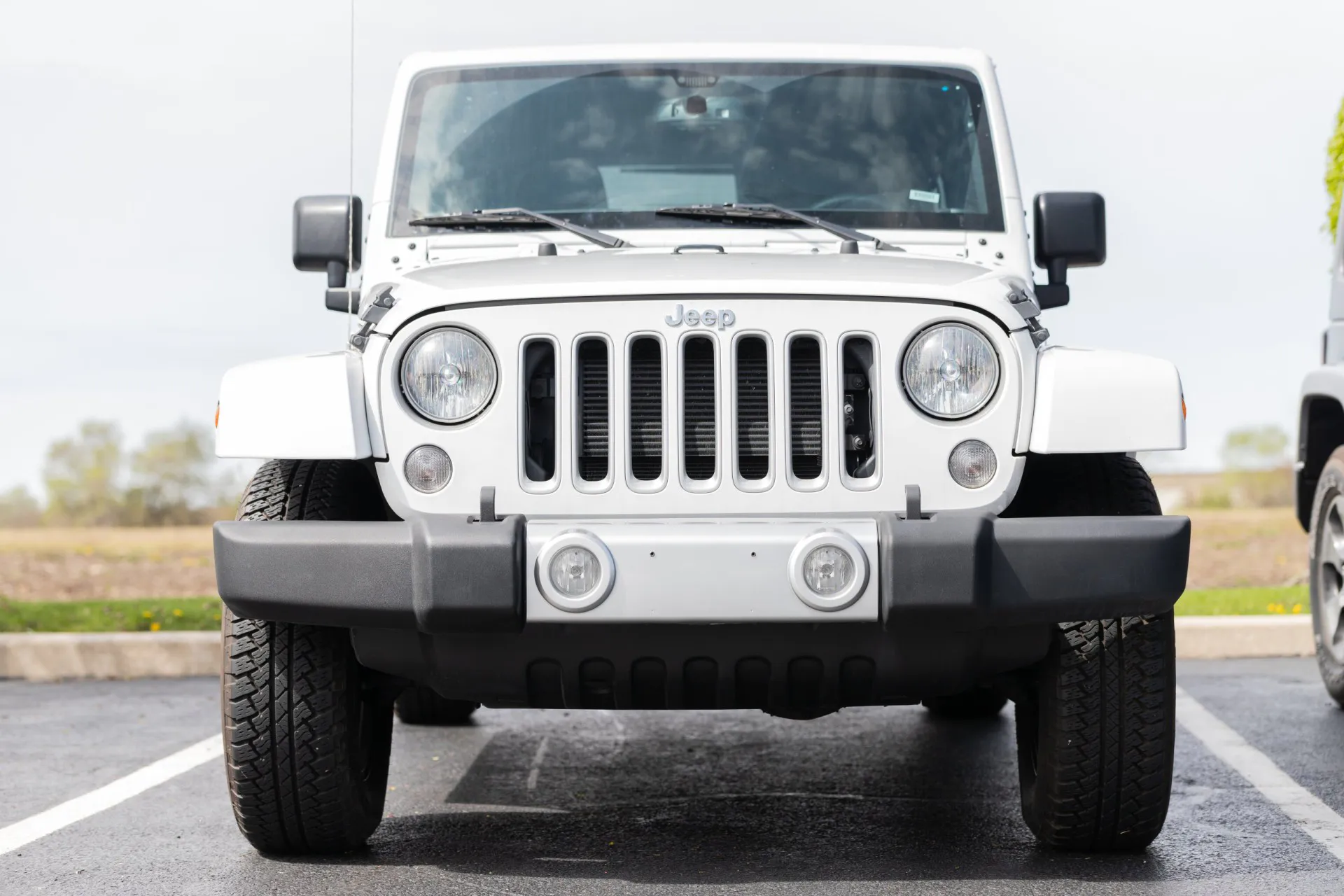 The front end of a white 2017 Jeep Wrangler 