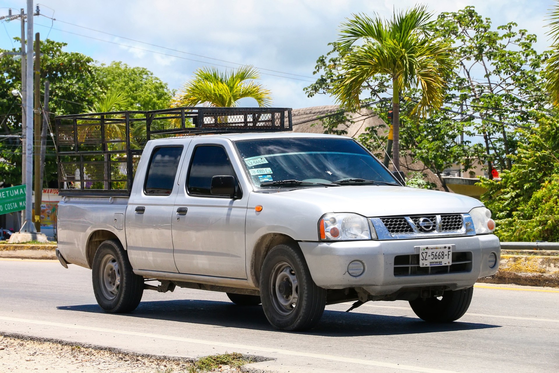 Pickup truck Nissan Frontier in the city street.