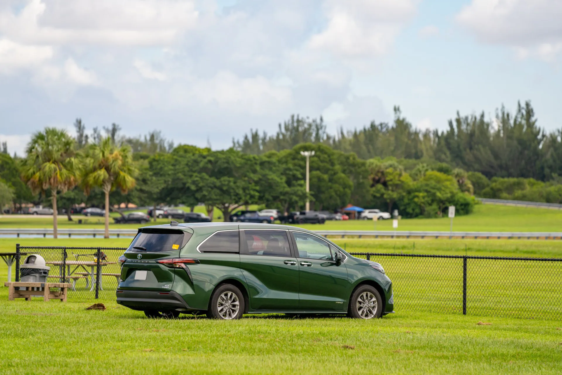 Rear quarter view of a 2021 Toyota Sienna parked on green grass