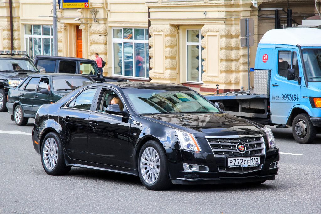 Black saloon car Cadillac CTS in the city street.