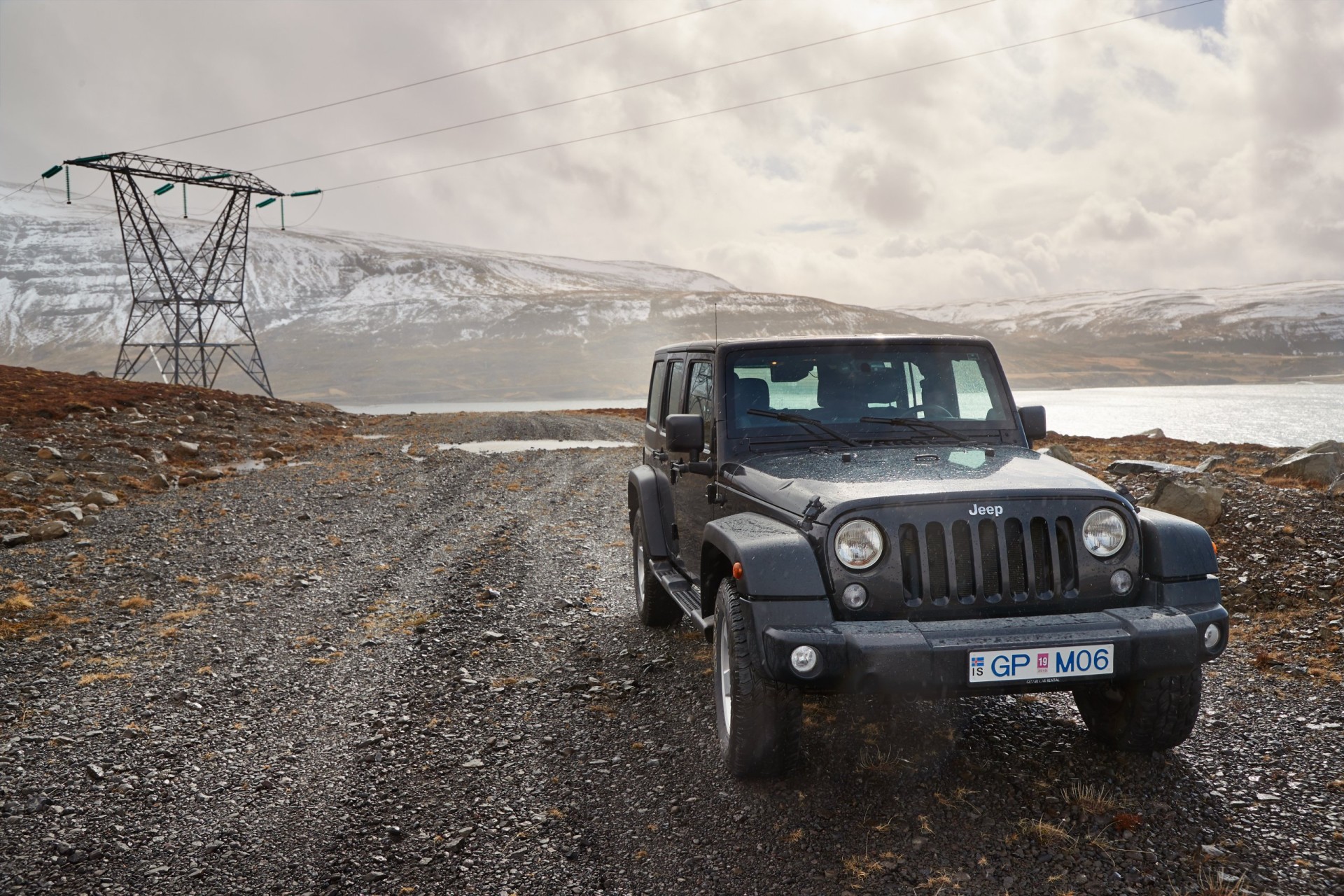 Jeep Wrangler vehicle on a path in the hills