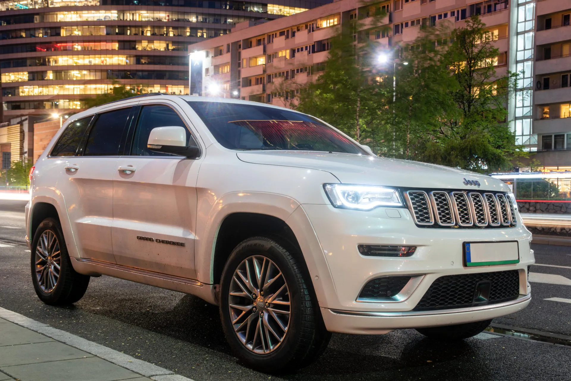 White Jeep Grand Cherokee parked along the city street