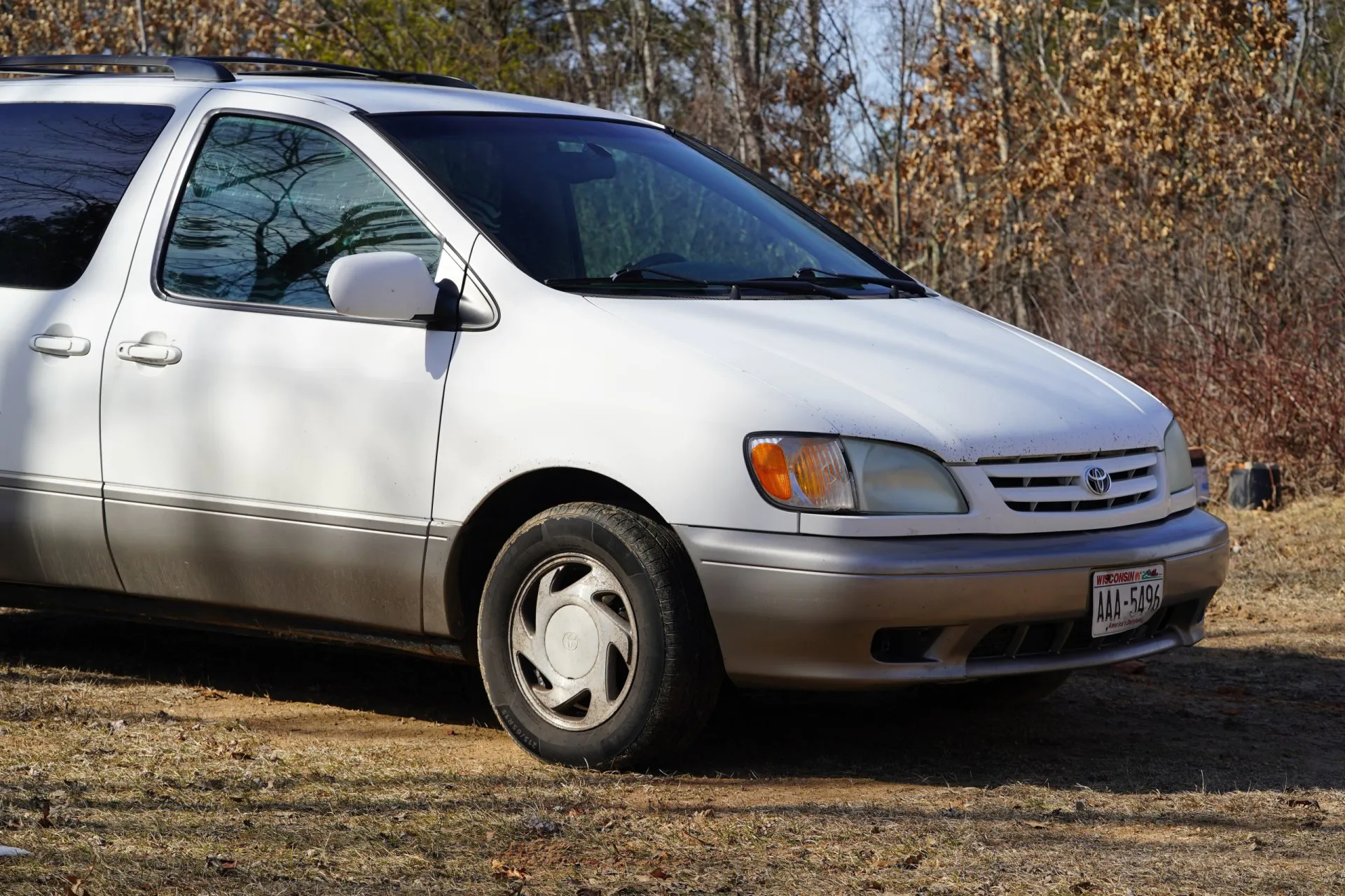 A 2002 White Toyota Sienna sits parked outside.