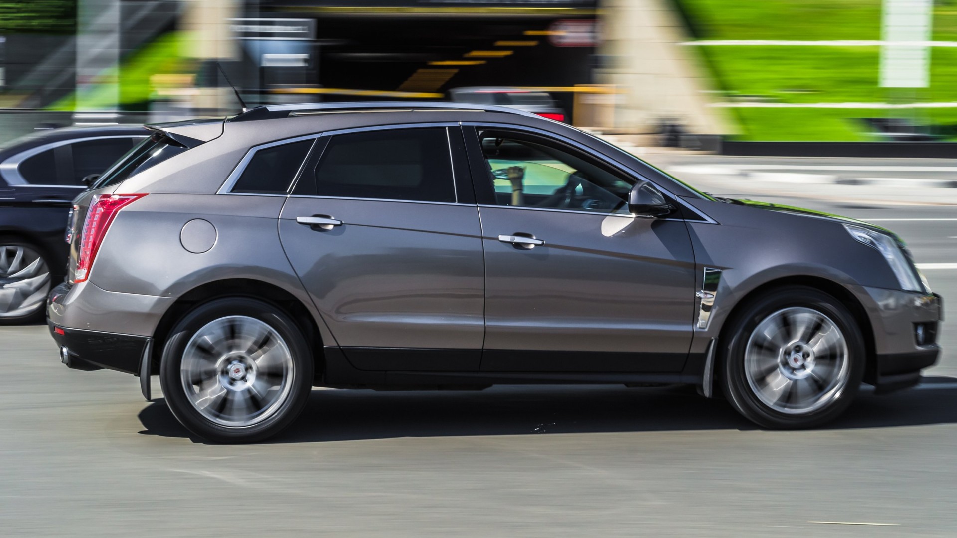 2010 Gray color Cadillac SRX Second generation in fast motion on the street