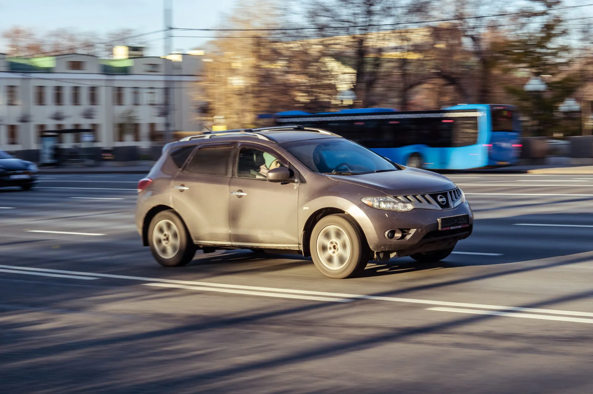 2010 Brown Nissan Murano on the city street with blurred background