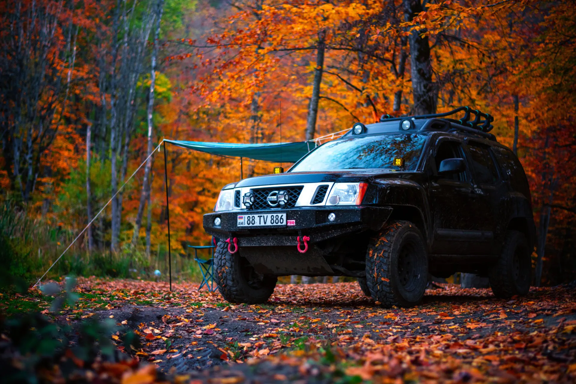 2011 Nissan Xterra parked in the forest on an autumn season
