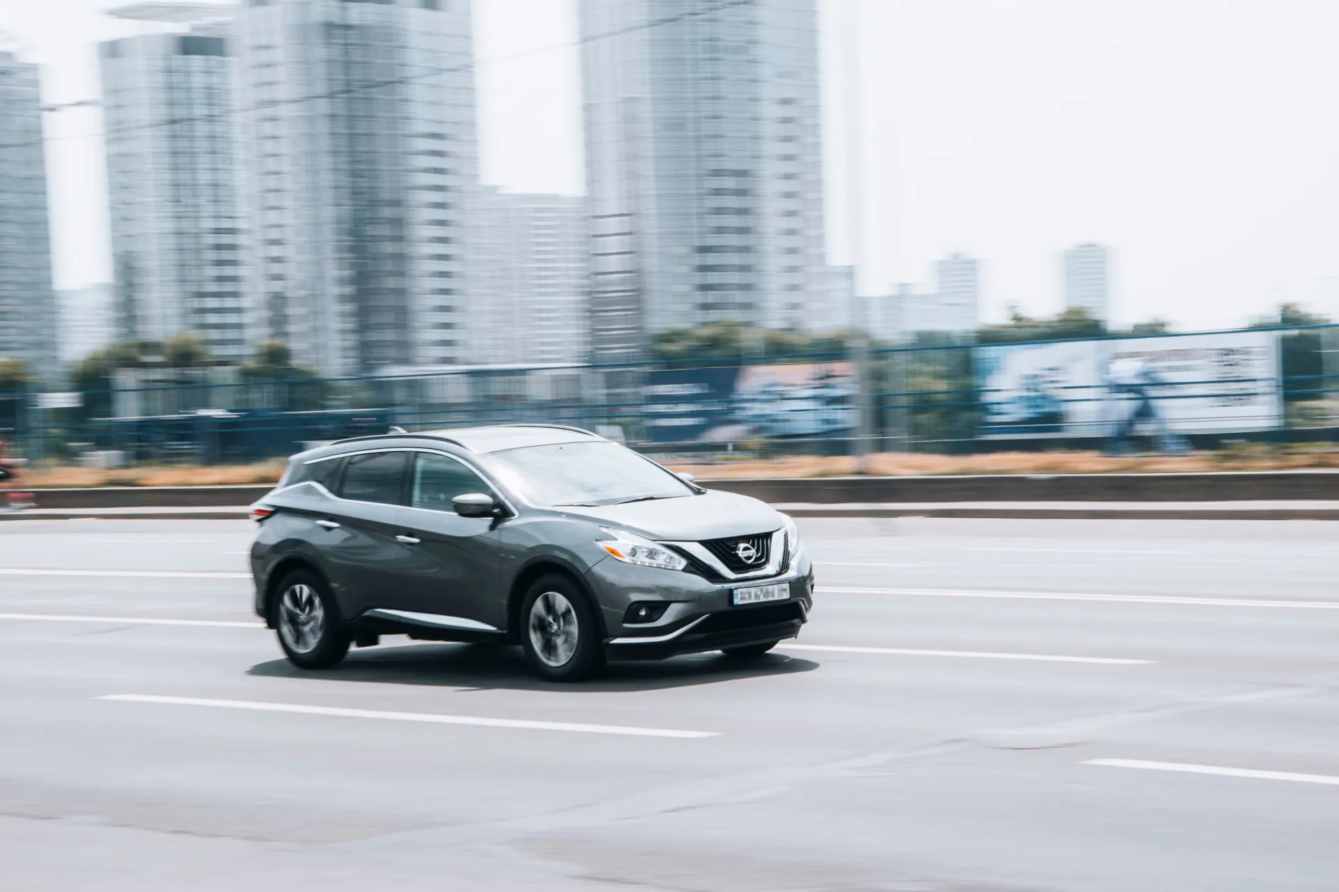 2016 Gray Nissan Murano car moving on the street.