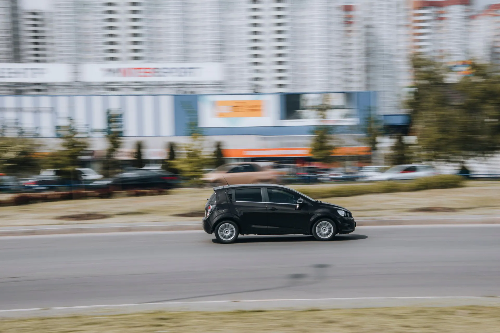 2017 Black Chevrolet Sonic car moving on the street