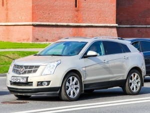 Luxury crossover Cadillac SRX at the city street.