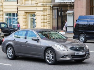 Compact executive car Infiniti G35 in the city street.