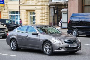 Compact executive car Infiniti G35 in the city street.