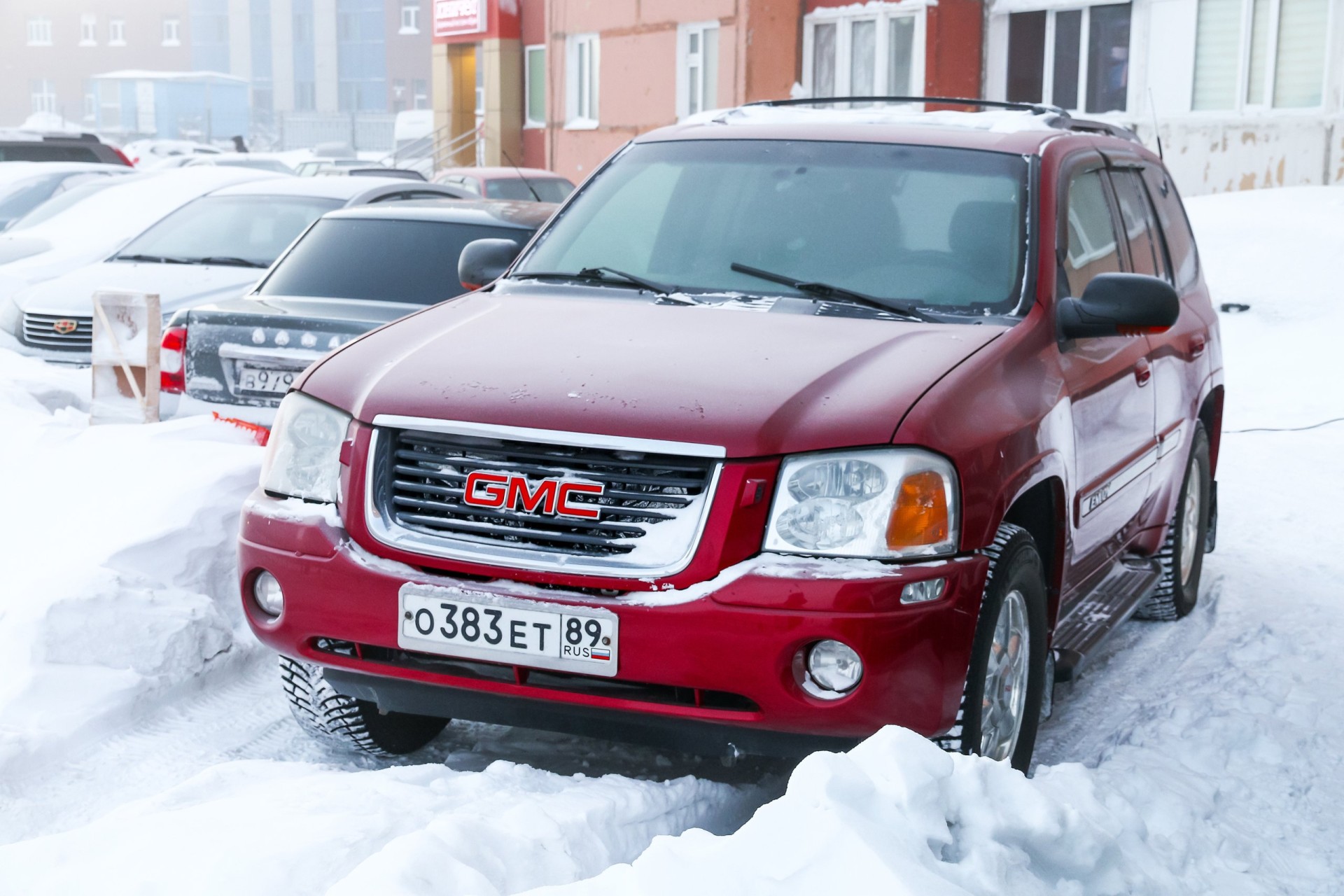 2003 GMC Envoy parked at a snowy residential area