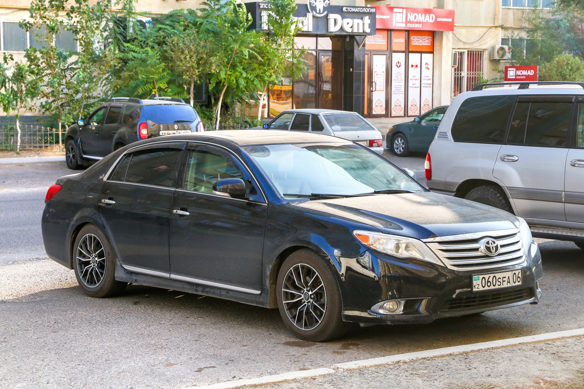 2012 Black Toyota Avalon in the city street.