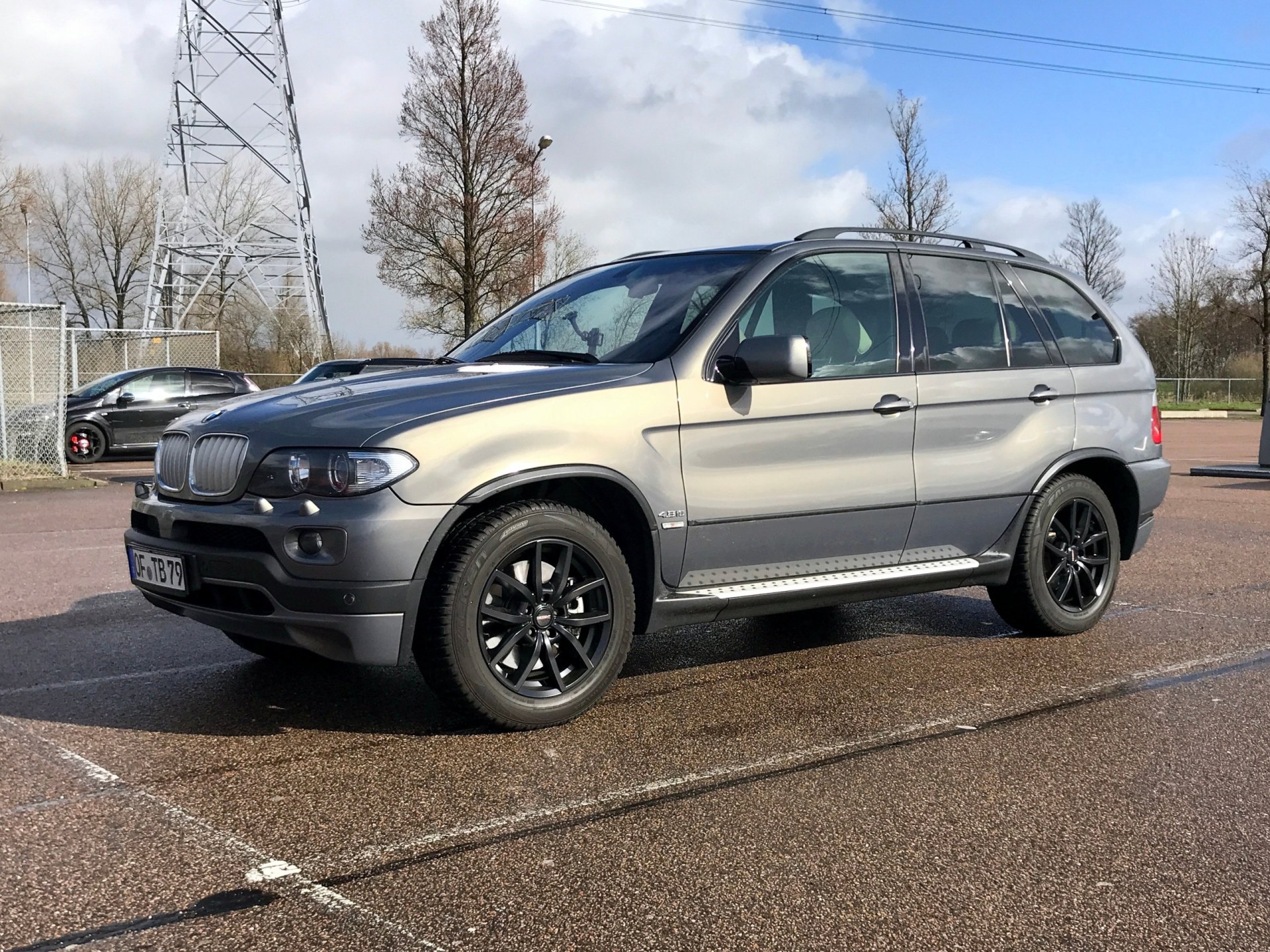BMW X5 parked on a public parking lot. Nobody in the vehicle.