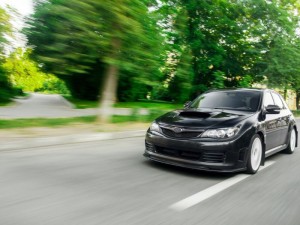 Black Subaru Imprez in motion at a city street