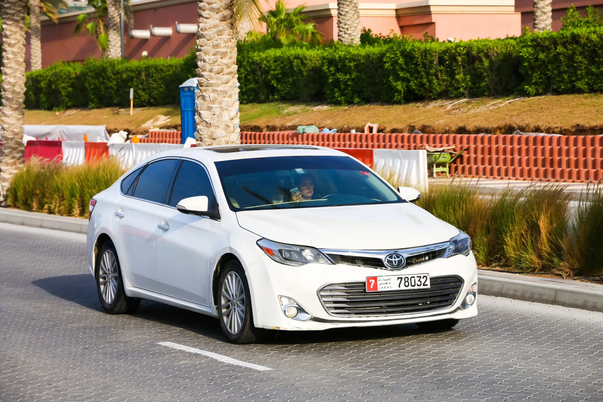 2014 White motor car Toyota Avalon in the city street.