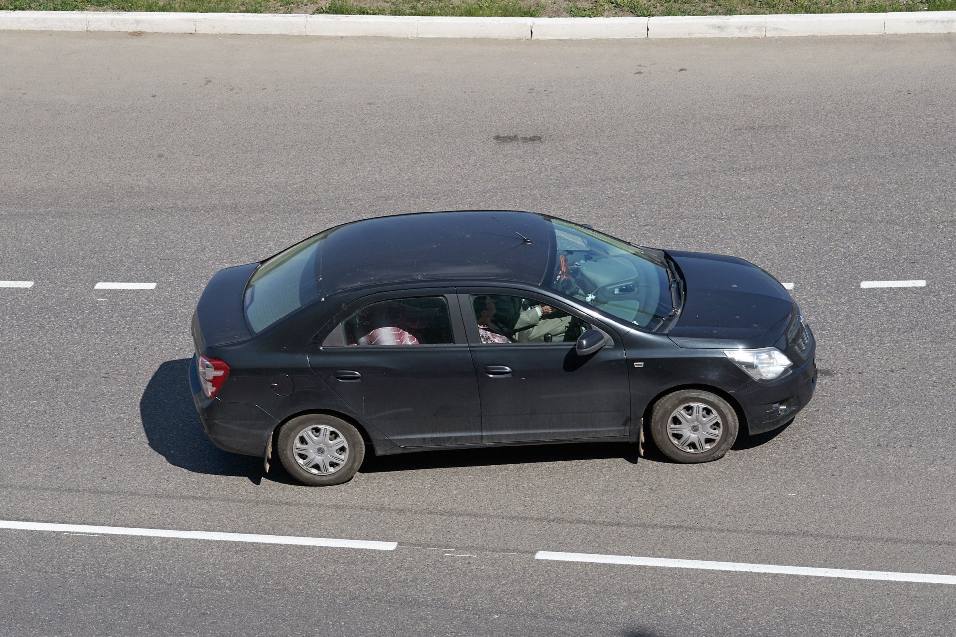 Black Chevrolet Cobalt moving in the city street