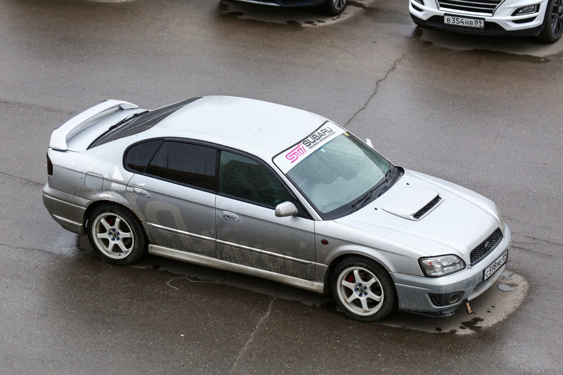 2002 Grey Subaru Legacy in the city street.