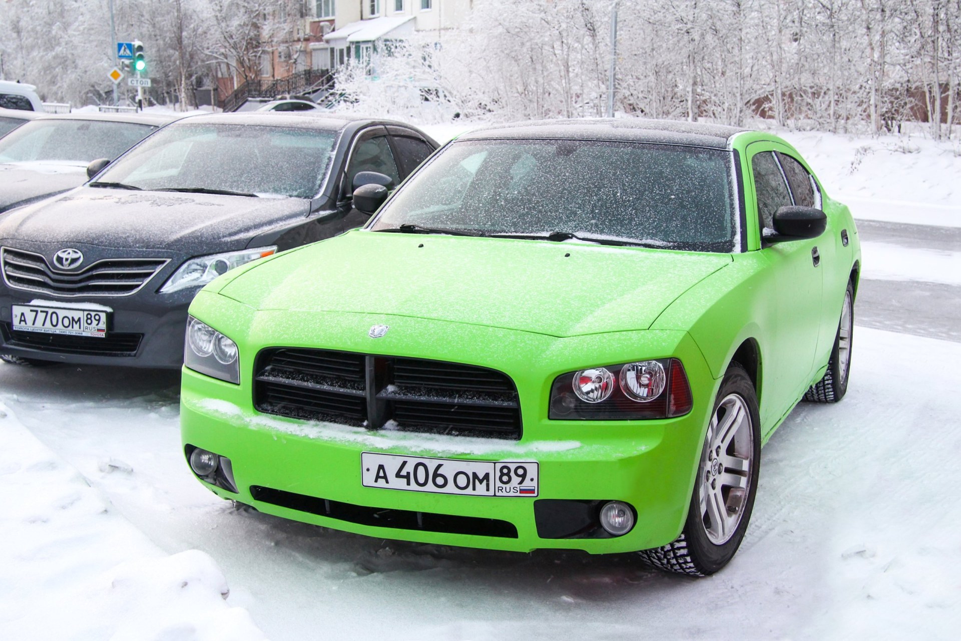 2007-2009 Green saloon car Dodge Charger in a city street.