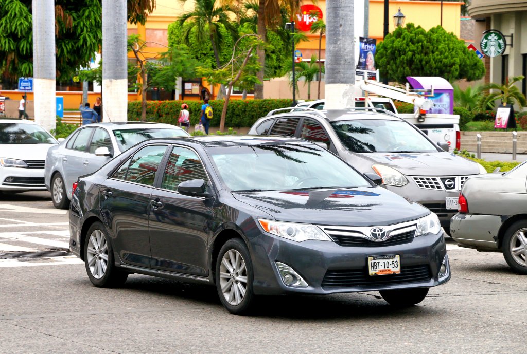 Black motor car Toyota Camry in the city street.