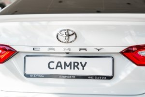 rear view. new white car Toyota Camry in the premises of the dealership of Toyota cars.