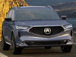 Acura MDX traversing the mountainside with the ocean in its background