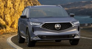 Acura MDX traversing the mountainside with the ocean in its background