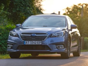 Panoramic view of new shiny expensive Subaru Legacy car parked on city street
