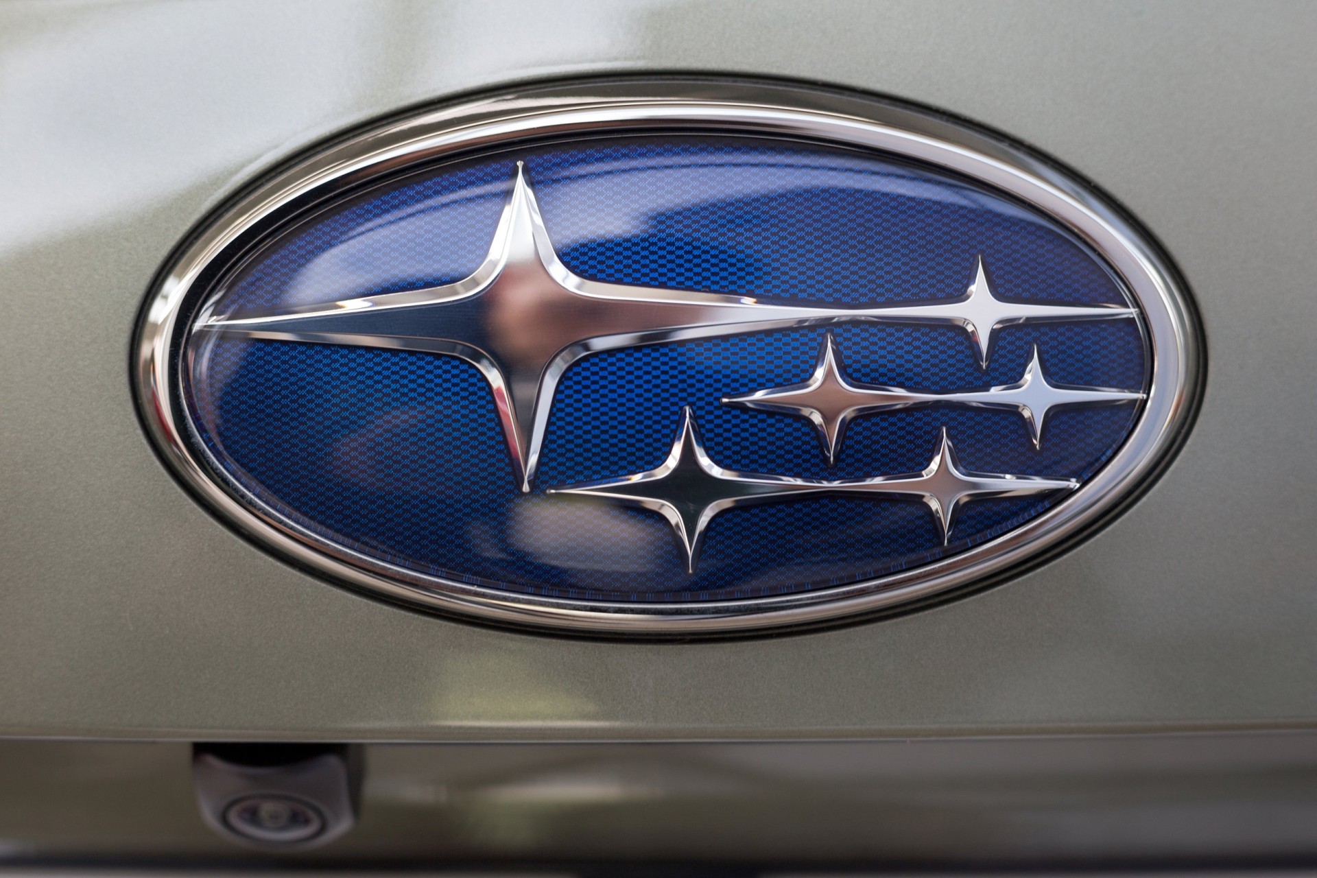  Logo of Subaru car on display in the dealer showroom.