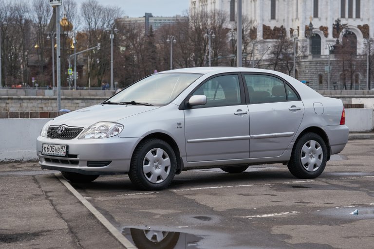 The Toyota Corolla (E120) car parked on a city street.