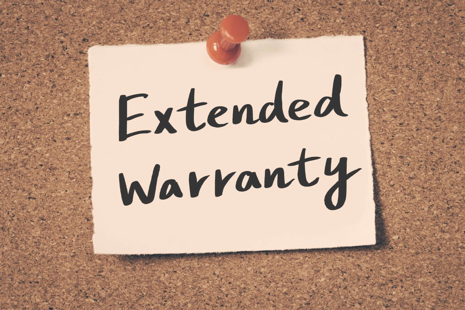 Extended Warranty Sign on a corkboard