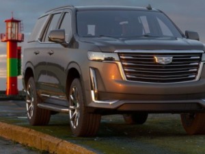 Cadillac Escalade parked roadside at sunset