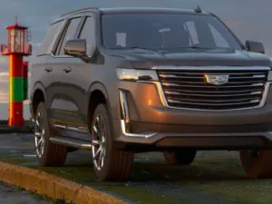 Cadillac Escalade parked roadside at sunset