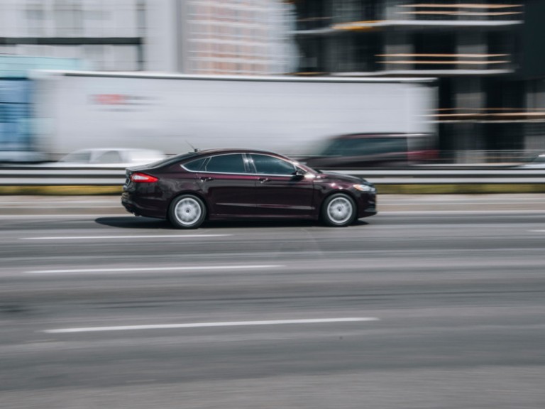 Purple Ford Fusion car moving on the street