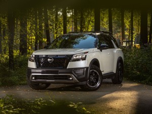 white Nissan Pathfinder Rock Creek SUV parked in the forest, front view