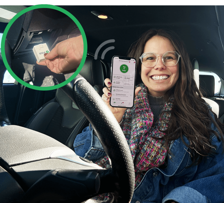 woman sitting in driver's seat showing the FIXD app on her phone